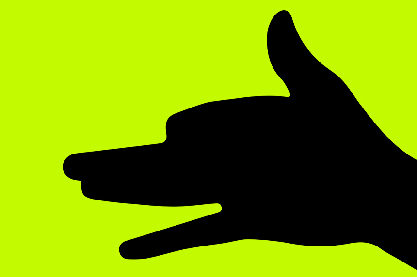 a silhouette of a hand on a yellow background gives a symbol with one finger pointed down making a dog shadow puppet
