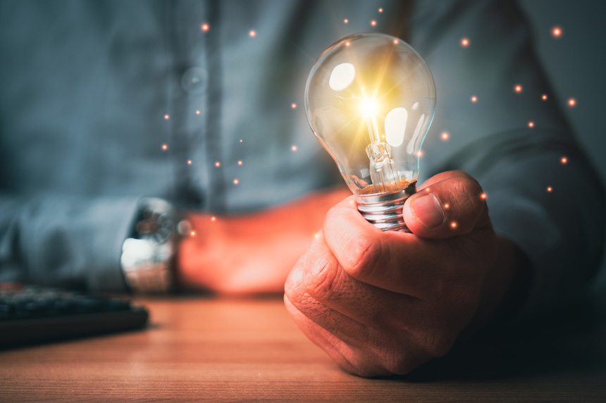 man holding bright lightbulb