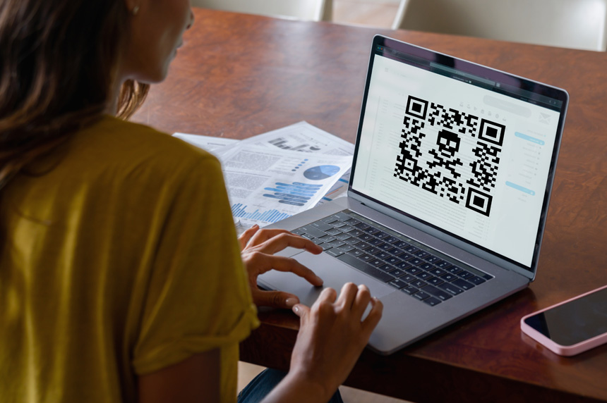 a laptop with a skull inside a QR code