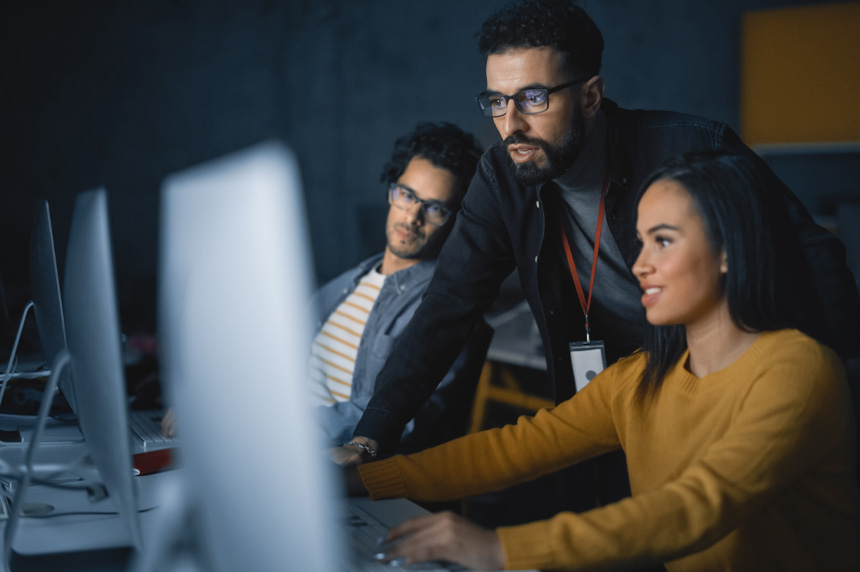 three workers at computer