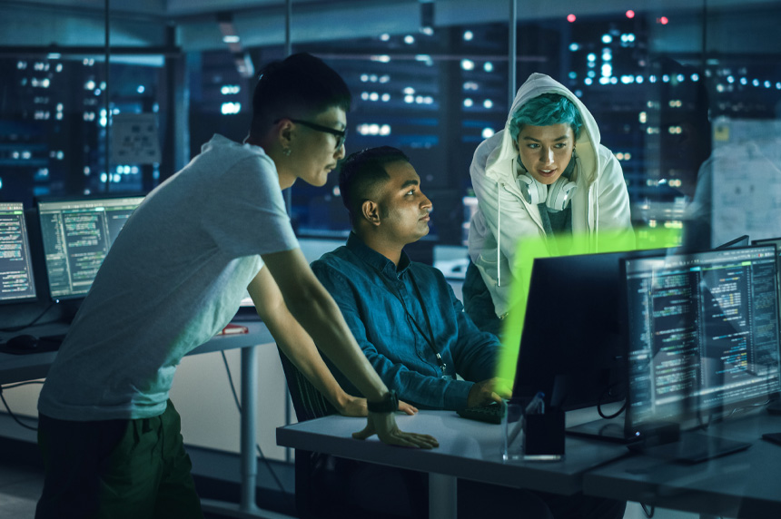 People standing around a computer