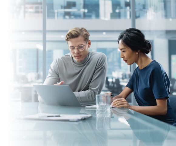 man and woman working on computer