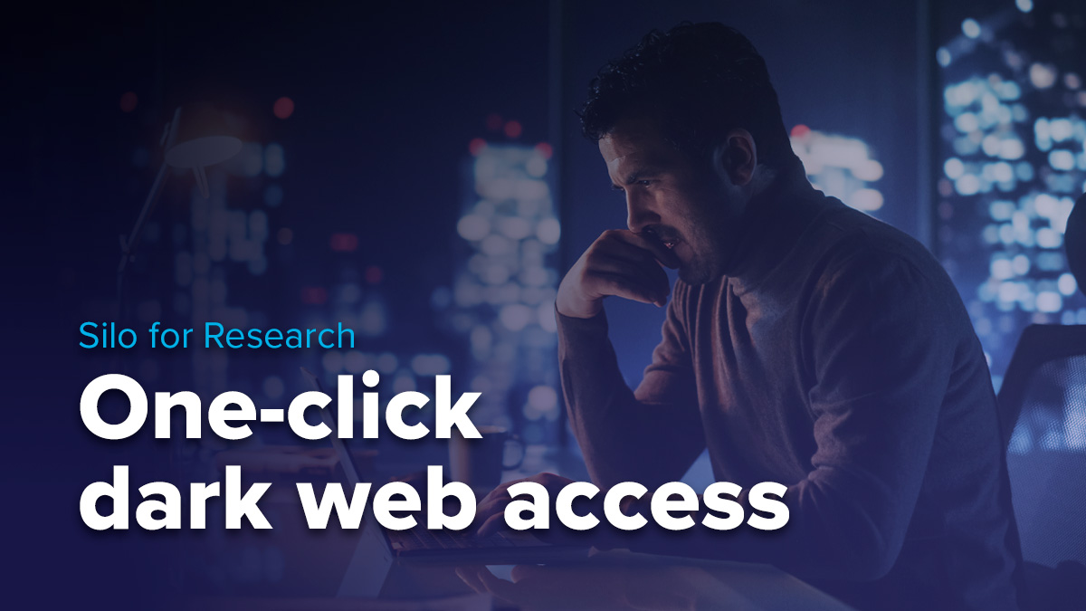 man sitting at computer researching dark web