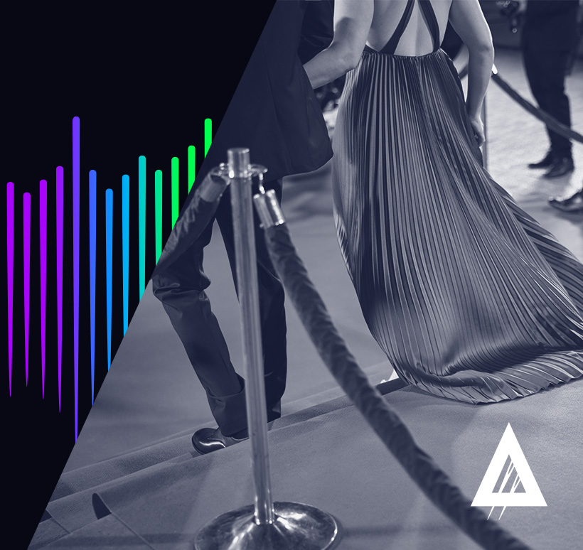 Person walking on a red carpet event, with a focus on their elegant pleated skirt. The left side of the image features a colorful audio equalizer graphic.