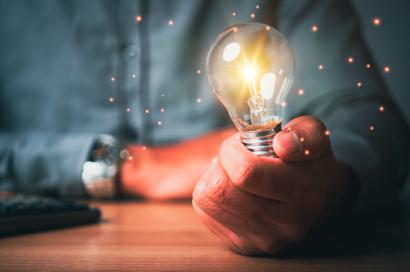 man holding bright lightbulb