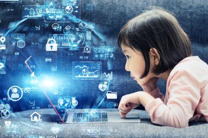 child looking at laptop screen, graphic overlay of cyber graphic