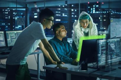 People standing around a computer