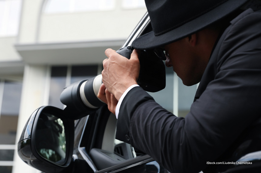 spy taking photos from vehicle